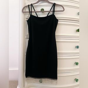 black mini dress, with rhinestone fringe detailing on the bottom